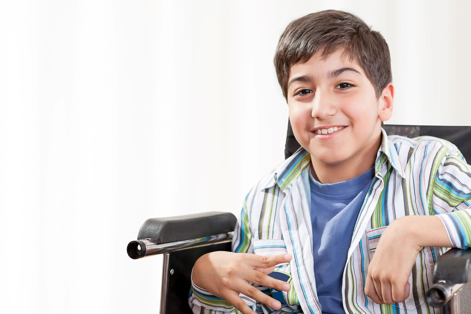 boy in a wheelchair smiling
