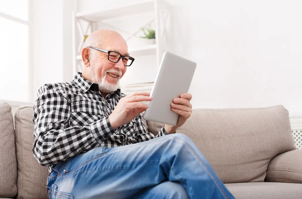 Older man reading a tablet